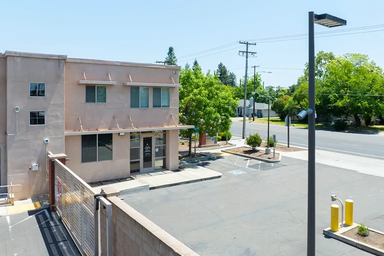 Self storage office building with street-facing access and parking area